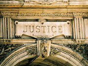 Picture of the word Justice on outside of building.